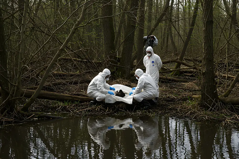 bio-recovery crime scene cleanup crew picking up a body