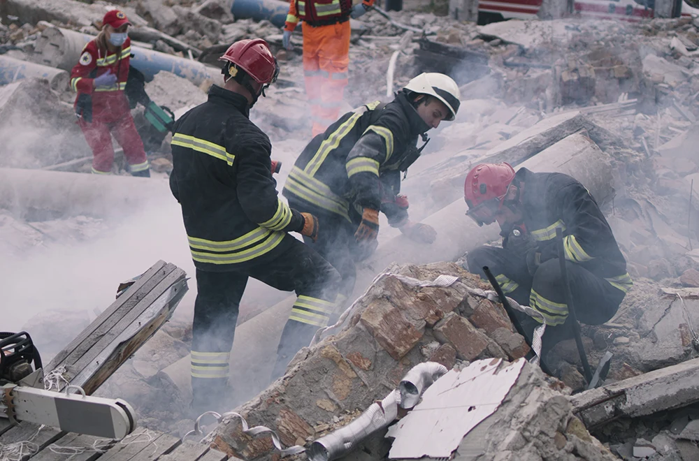 tornado-damage workers searching for survivors in building rubble after a tornado