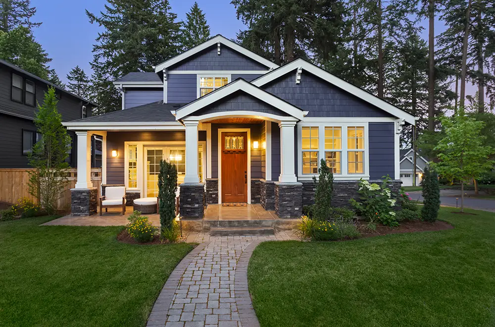 a blue house with lights on